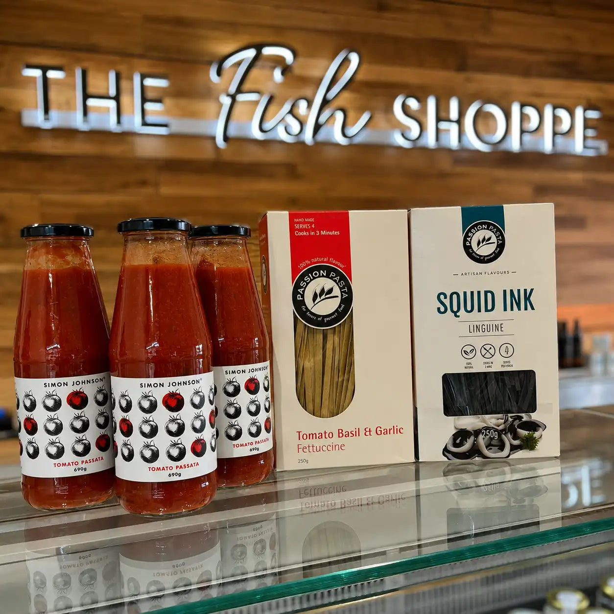 Premium pasta and gourmet pantry products displayed at The Fish Shoppe Collingwood, including Simon Johnson tomato passata and artisan squid ink linguine.