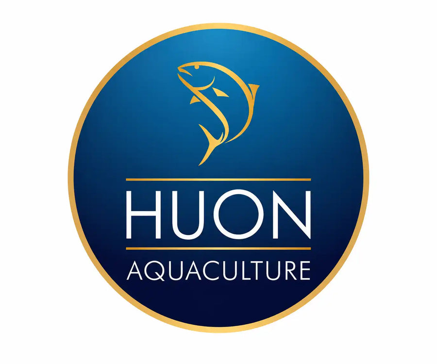 A circular blue and gold logo featuring a stylized gold fish above the text 'HUON AQUACULTURE' in white, centered on a light gray background.