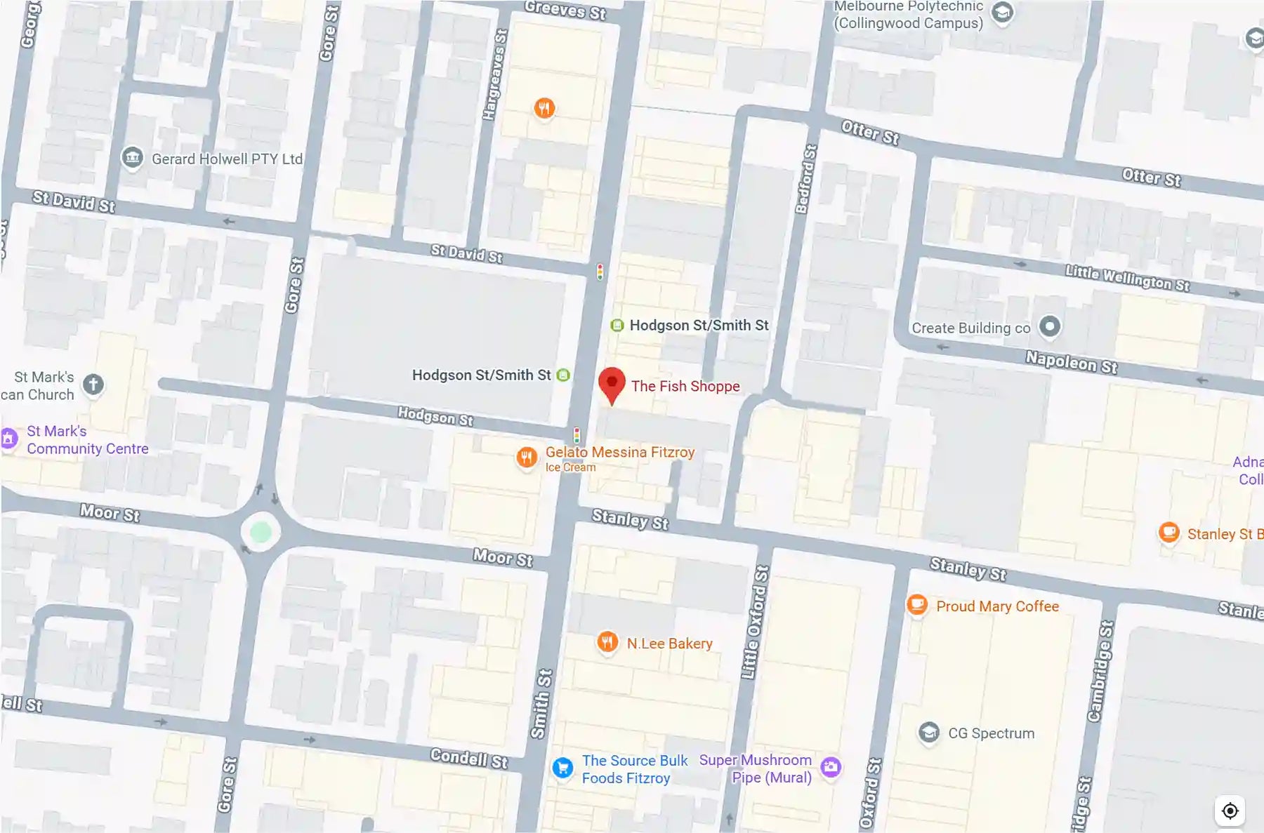 A close-up screenshot of a street map showing grid roads, labeled streets, landmarks, and colored icons on a mostly white and light gray background.