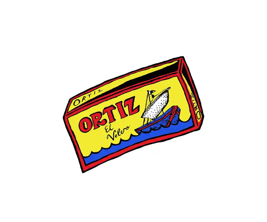 A stylized illustrated package of Ortiz el Velo cheese, shown at an angle on a plain white background. The box is primarily yellow with red lettering, a red border, blue wave details, and a small fish illustration.