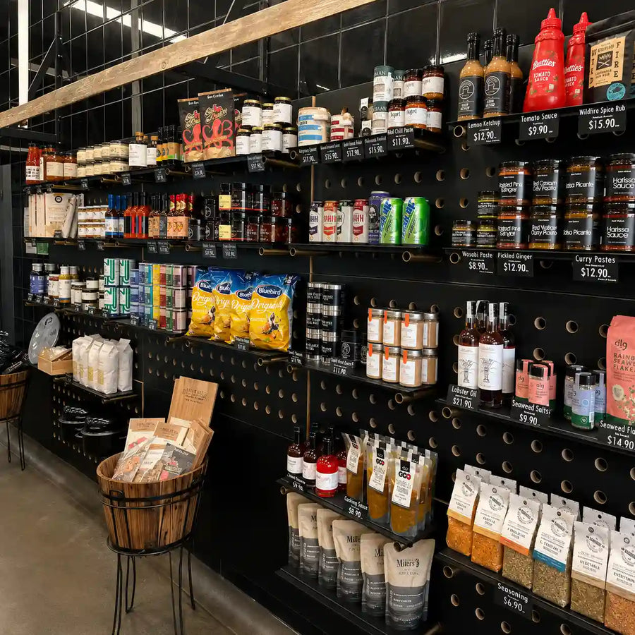 Gourmet pantry shelves at The Fish Shoppe Collingwood featuring premium sauces, spices, condiments, pasta, seasonings and specialty seafood accompaniments.